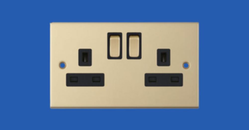 Brass-finish double switched socket with black inserts, an example of a decorative wiring accessory finish